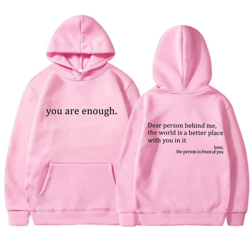 Pink hooded jumper flat lay showing the front chest text and the back print with kangaroo pocket