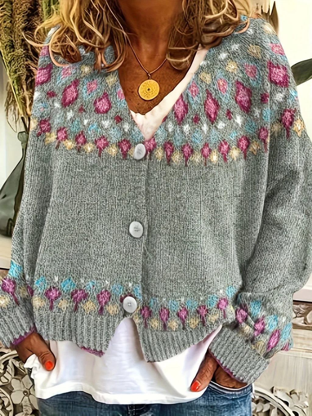 Front view of the same cardigan in grey marl with pink, blue and yellow Fair Isle yoke pattern and white buttons