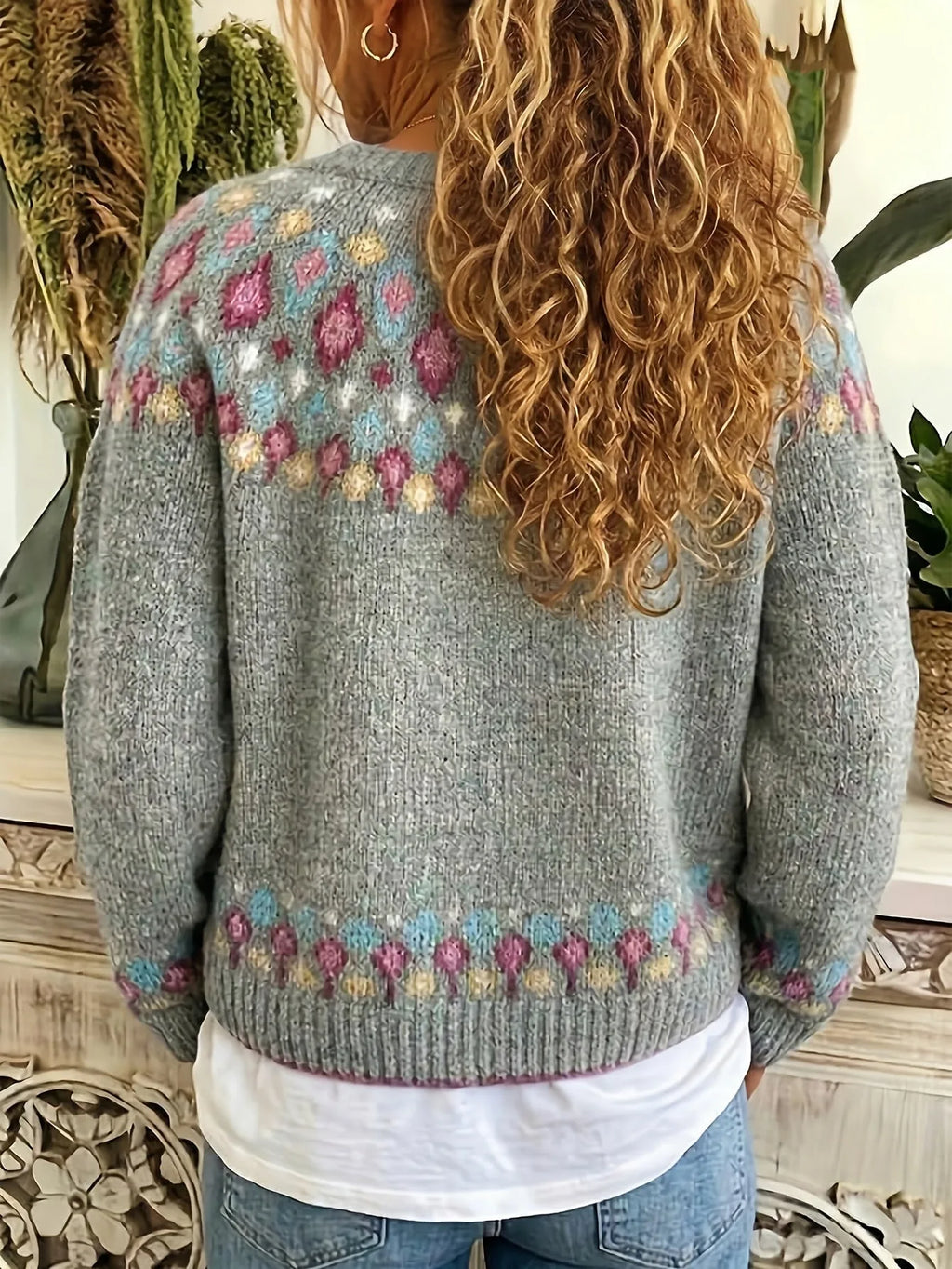 Back view of a model wearing the grey cardigan, showing the Fair Isle shoulder pattern and ribbed hem detail