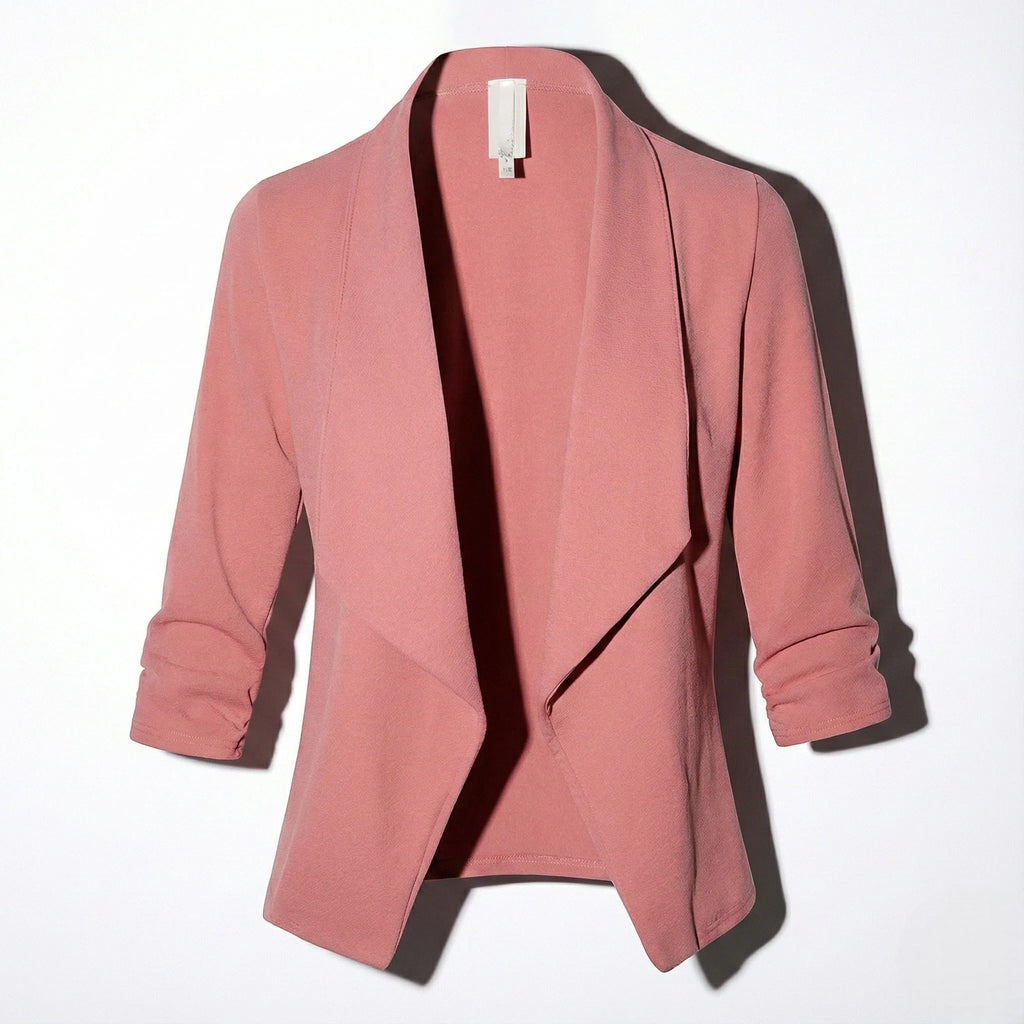 Pink open-front blazer laid flat, showing draped lapel and ruched three-quarter sleeves