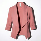 Pink open-front blazer laid flat, showing draped lapel and ruched three-quarter sleeves