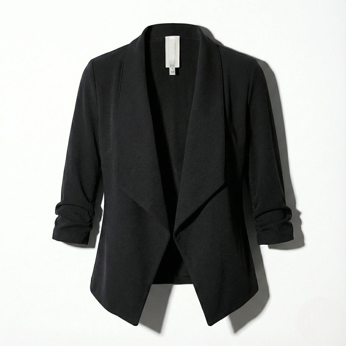 Black open-front blazer laid flat, highlighting the structured collar and clean front edge