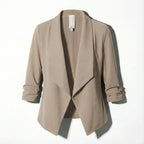Beige open-front blazer laid flat, showing the draped lapel and soft textured fabric