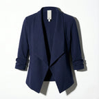 Navy open-front blazer laid flat, showing the structured silhouette and gathered cuffs