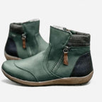 Side view of green leather ankle boots with side zip, tan pull tab and contrast heel panel