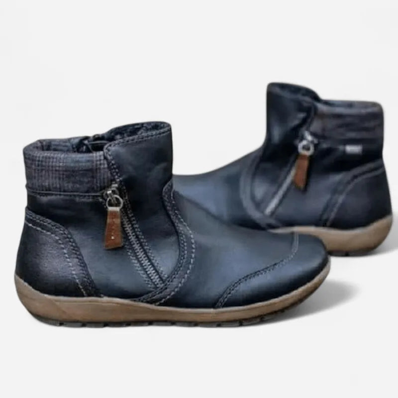 Pair of navy leather ankle boots showing checked fabric cuff and brown sole