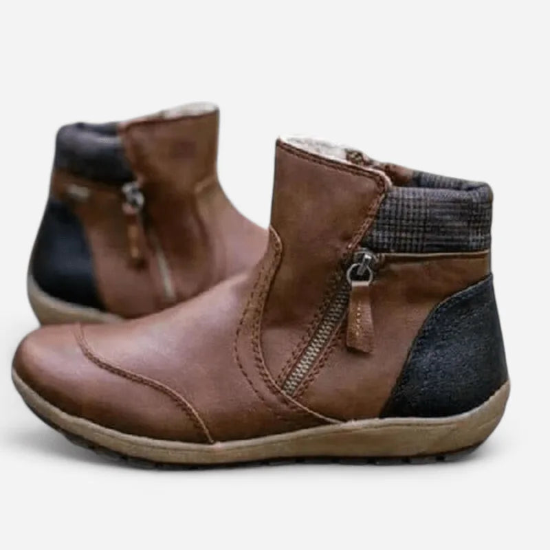 Brown leather ankle boots with visible topstitching, side zip and cushioned wedge sole