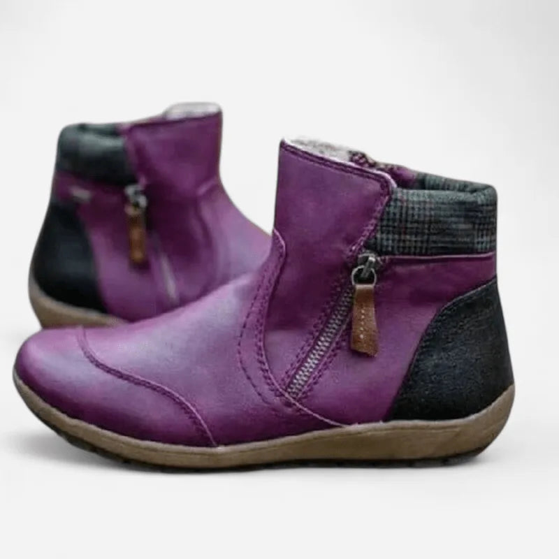 Purple leather ankle boots with black heel panel and checked cuff detail, angled view