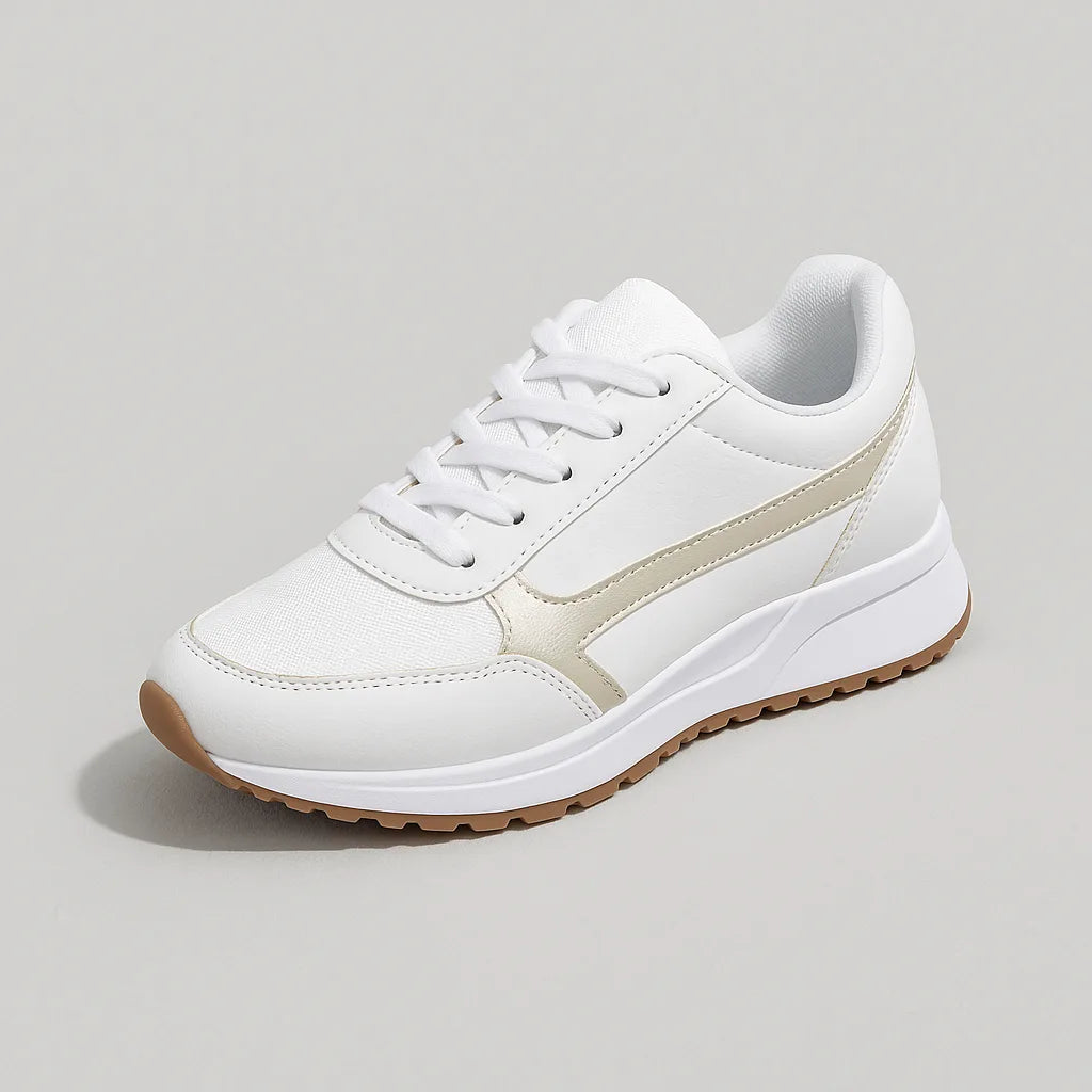 Studio shot of a single white trainer with cream panelling, white laces and a gum-tone chunky sole on a plain background