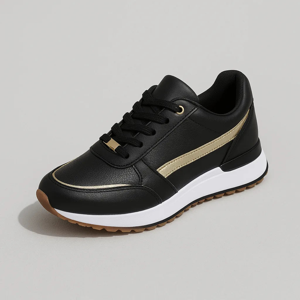 Studio shot of a single black trainer with metallic gold stripe, black laces and a white and gum two-tone sole