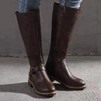 Front view of dark brown knee-high boots showing side zip closure and stacked block heel