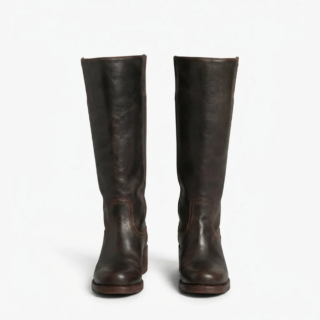 Front view of dark brown leather knee high boots side by side, showing stitched panel detail at the ankle