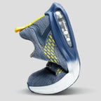 Studio shot of the trainer's heel and visible air cushion unit, showing the yellow pull tab and knit collar