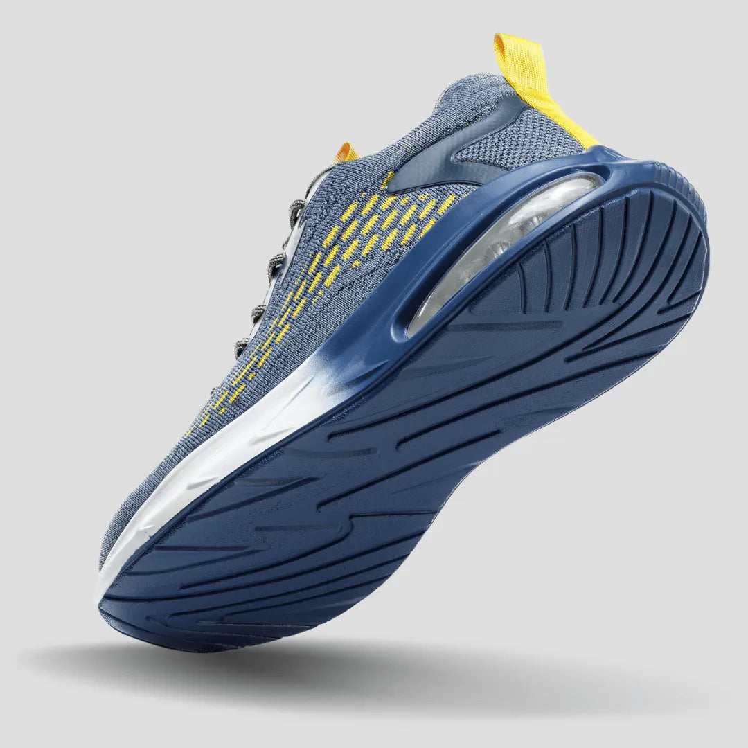 Underside angled view revealing the deep tread pattern and visible air cushion pod in the heel