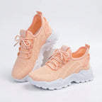 Peach knit sneakers with white chunky sole shown in a crossed pair angle on a plain background