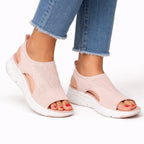 Pale pink knit slip-on sandal with open toe, white platform sole and slingback heel strap.