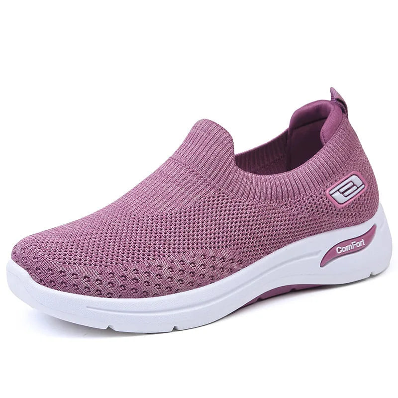 Side view of a mauve purple knit slip-on trainer with white sole and contrast heel tab