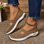 Brown knit slip-on trainers with cut-out detail and white sole, worn with denim and a chain-link anklet