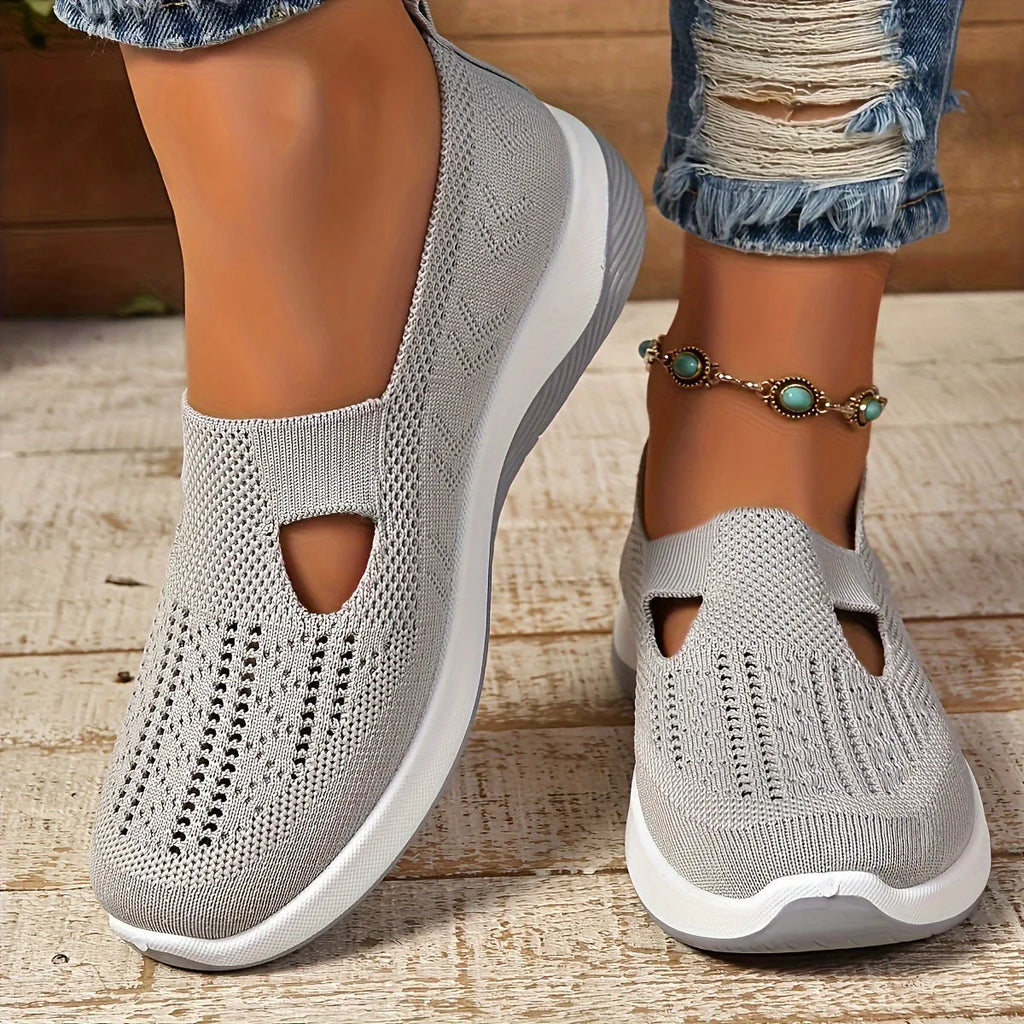 Top view of purple pair of knit slip-on trainers side by side showing woven diamond pattern and cut-out detail