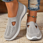 Top view of purple pair of knit slip-on trainers side by side showing woven diamond pattern and cut-out detail
