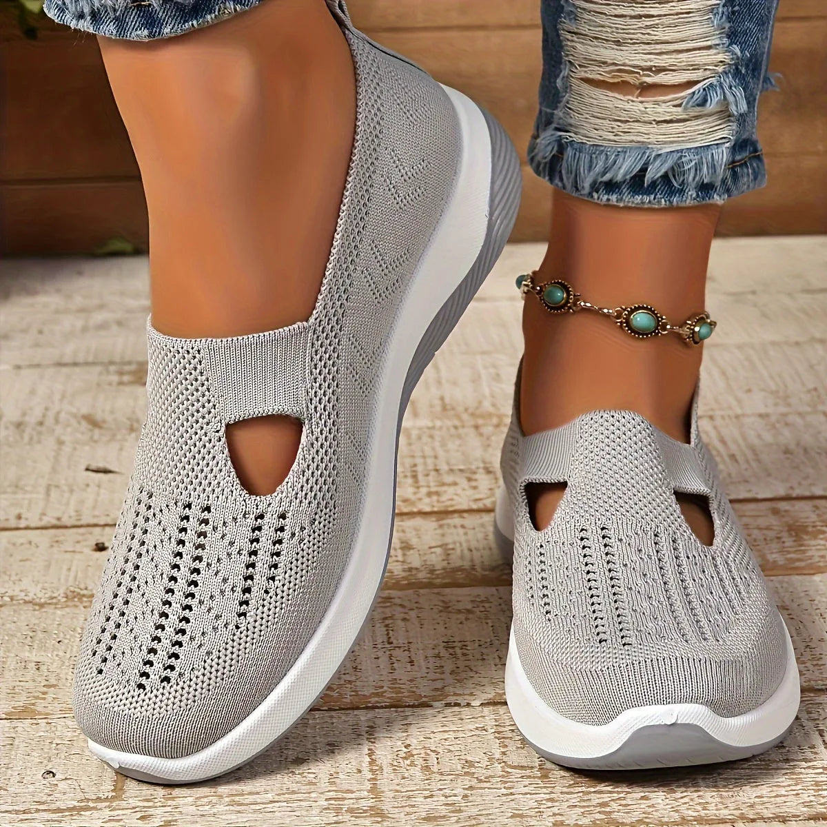 Top view of purple pair of knit slip-on trainers side by side showing woven diamond pattern and cut-out detail