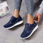 Navy blue lace-up trainer with diamante mesh panel and white platform sole, side zip visible