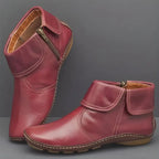 Pair of burgundy red leather ankle boots with fold-over cuff, side zip and stitched sole detailing