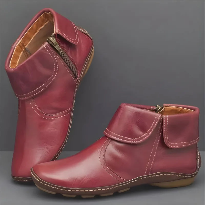 Pair of burgundy red leather ankle boots with fold-over cuff, side zip and stitched sole detailing