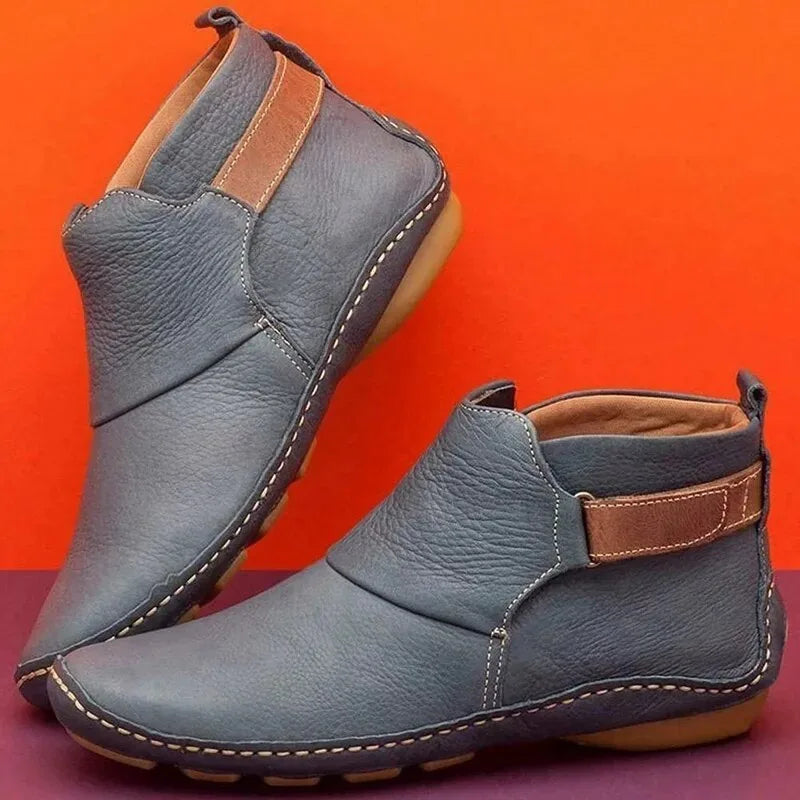 Deep red leather ankle boots with tan side strap and contrasting sole