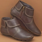 Dark brown leather ankle boots showing fold-down cuff, exposed zip and hand-stitched flexible sole