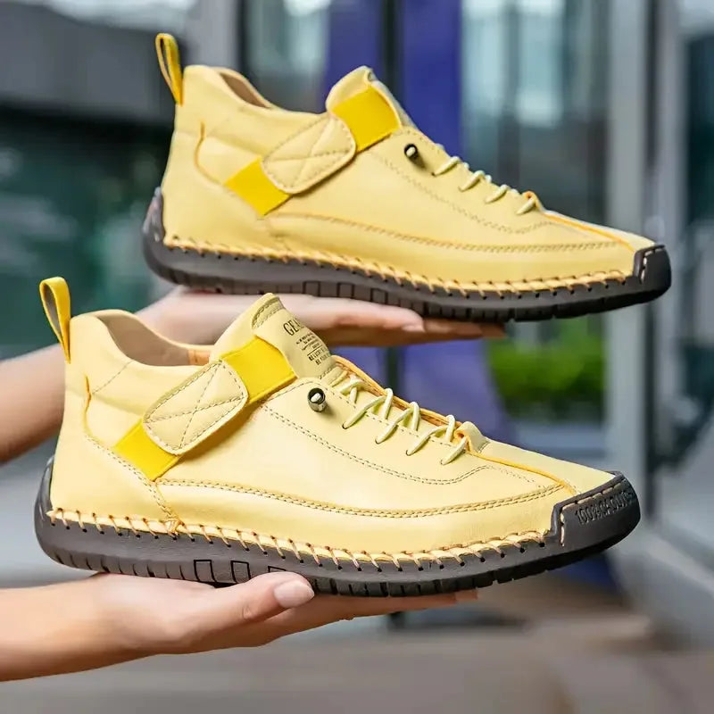 Side view of the beige trainer highlighting the woven leather panel, elastic gusset and stacked lug sole