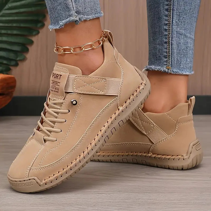 Beige tonal trainer with woven leather detailing on the toe and matching cream stitched sole
