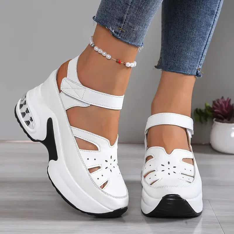 Close-up side profile of white platform sandal showing quilted ankle strap and layered wedge sole