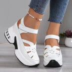 Close-up side profile of white platform sandal showing quilted ankle strap and layered wedge sole
