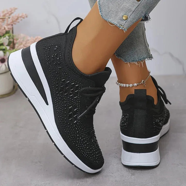 Grey knit trainers viewed from above and side, showing gold metallic star pattern on the toe