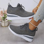 Navy blue knit trainers with sparkling rhinestone detailing shown from above and side, white sole