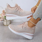 Pair of grey knit trainers with metallic gold star studs, lace-up design and white wedge sole