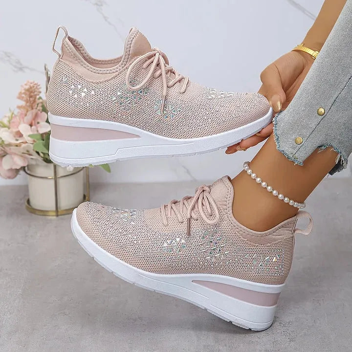 Pair of grey knit trainers with metallic gold star studs, lace-up design and white wedge sole