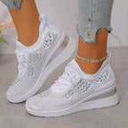 White knit trainers with silver rhinestone star design, side view showing lace-up front and wedge sole