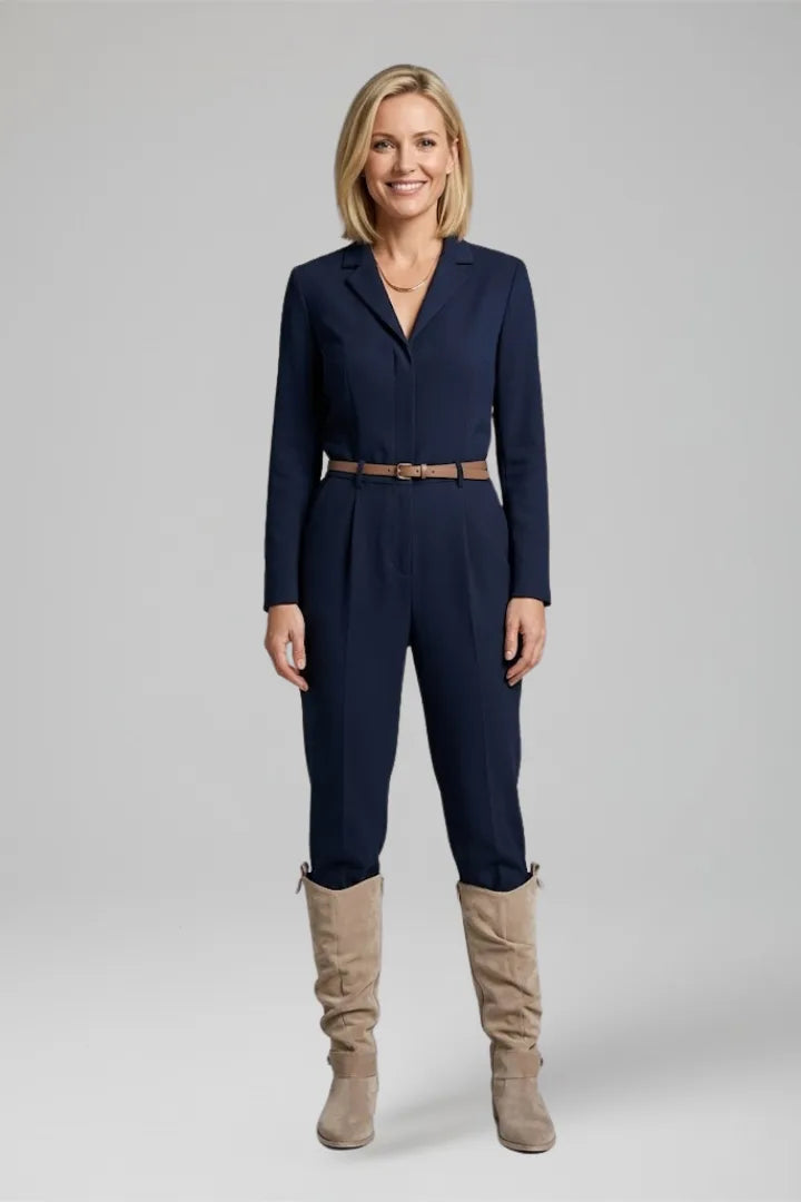 Woman wearing a navy jumpsuit styled with beige suede knee-high slouch boots for a smart casual look