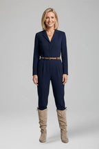 Woman wearing a navy jumpsuit styled with beige suede knee-high slouch boots for a smart casual look