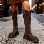Front-facing view of brown suede knee-high boots showing rounded toe and stacked block heel