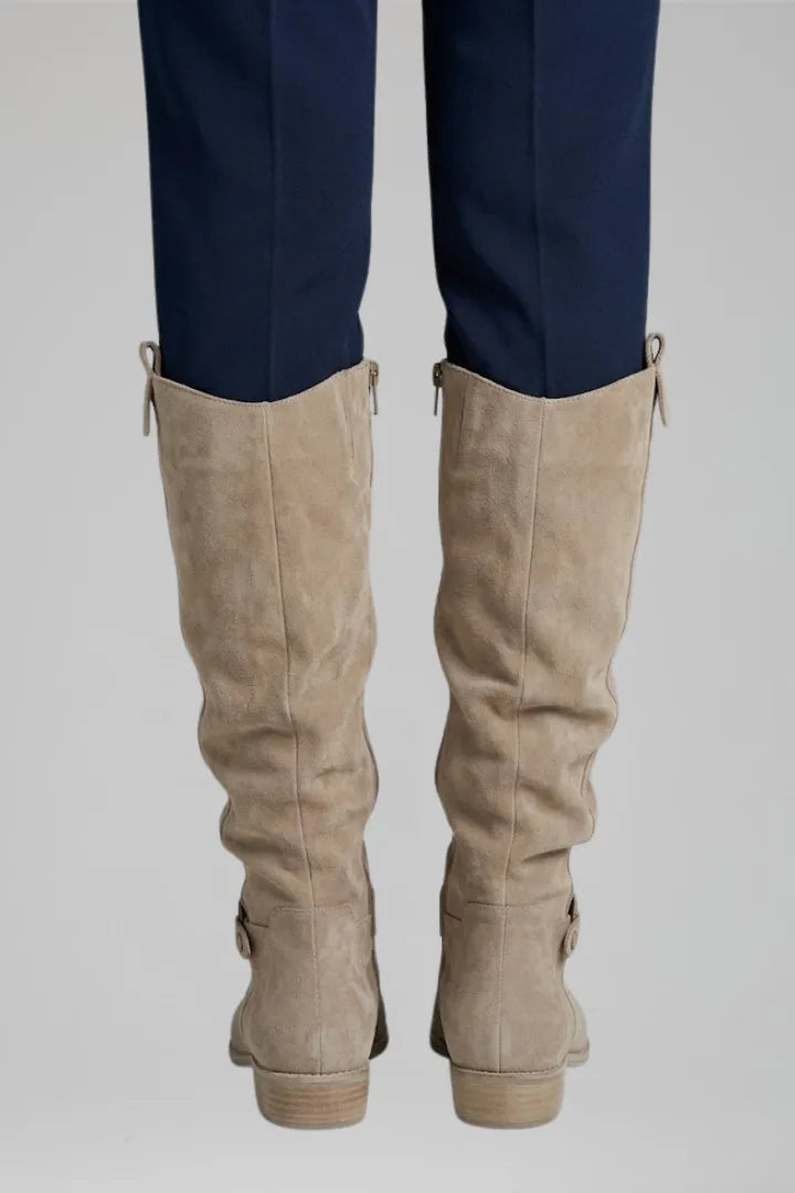 Close-up back view of both beige suede boots showing the ruched shaft and stacked block heel