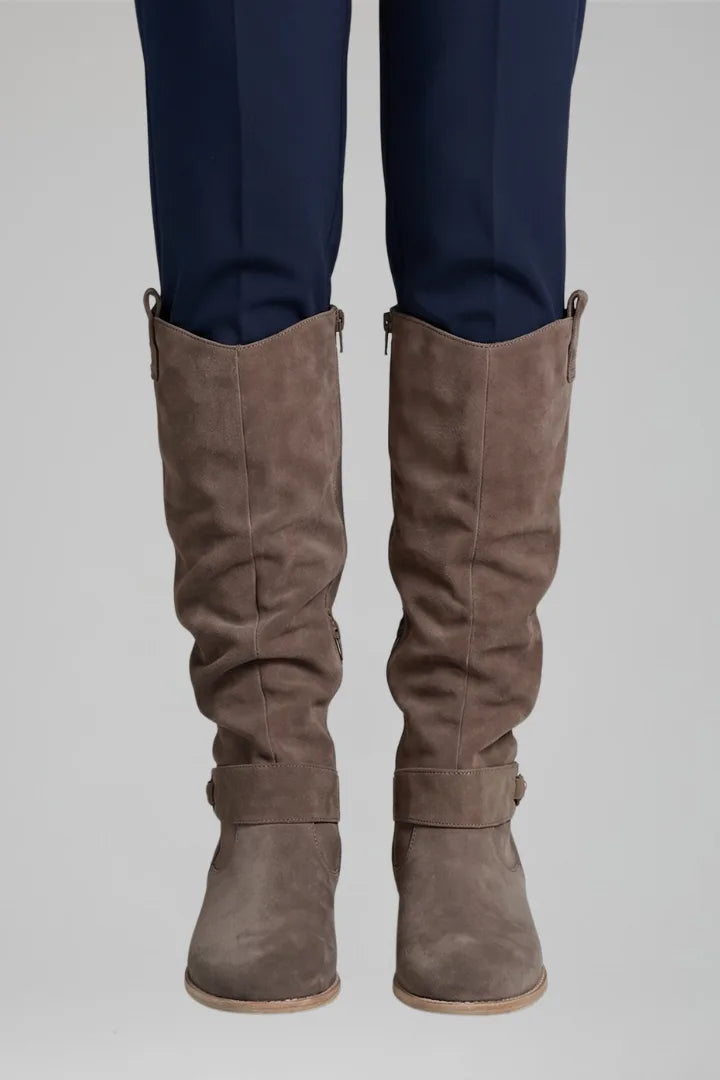 Front view of the boots shown in a darker taupe brown suede tone with visible zip and ankle strap