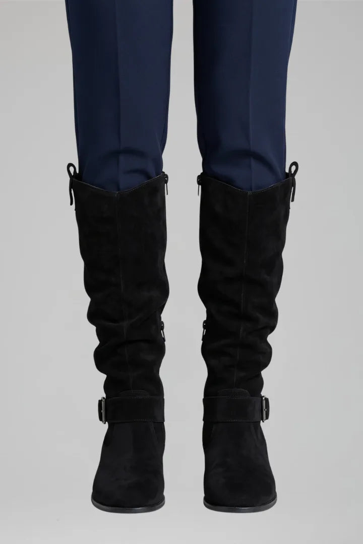 Front view of the boots shown in a khaki green suede tone with pull tab and buckle strap detail