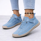 Pale sky blue suede trainers with contrast topstitching and a tan ridged sole, worn with cropped light-wash denim