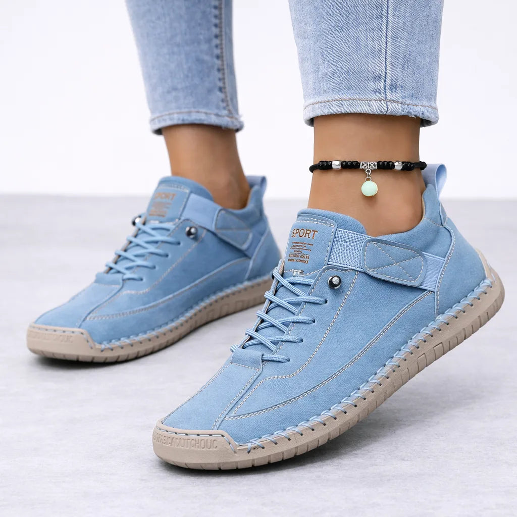Pale sky blue suede trainers with contrast topstitching and a tan ridged sole, worn with cropped light-wash denim
