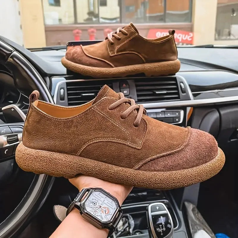 Detail shot of the lace-up front of a tan suede derby shoe with woven cotton laces