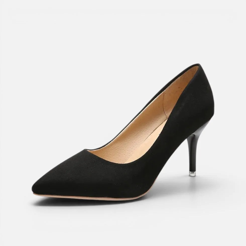 Side view of black suede pointed toe pump with slender kitten heel and smooth finish