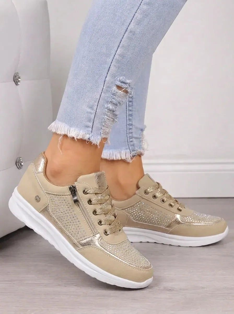 Pair of navy suede trainers shown from above with laces tied in a bow and crystal mesh toe